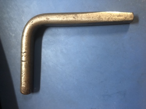  Alt text  Metal object shaped to form a key to unlock a door known as a square key