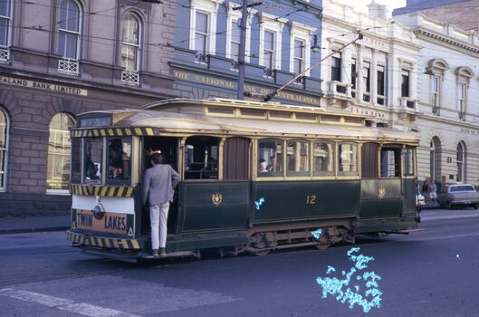 Passengers boarding tram 12 in Lydiard St North