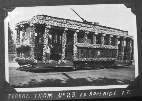 Vintage tramcar decorated with thousands of flowers for a celebration, with "VIEW POINT" visible on the front.