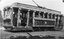 Vintage tramcar decorated with thousands of flowers for a celebration, with "VIEW POINT" visible on the front.