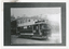 A vintage Ballarat Tramways tram is parked on a street in front of a building. A banner advertising a "JACOS BOOT SALE" is stretched across the side of the tram.