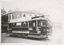 A vintage Ballarat Tramways tram is parked on a street in front of a building. A banner advertising a "JACOS BOOT SALE" is stretched across the side of the tram.