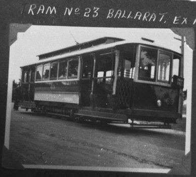Tramcar numbered 69 with an "RUBICON STREET" sign, parked on a street with a man standing at the rear.