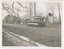 A vintage tram numbered 28 travels down a road lined with trees and a ditch.