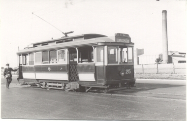 A vintage tram labeled "BELMONT" and "25" is stopped on a street next to a uniformed man. In the background, a tall industrial chimney and buildings are visible.