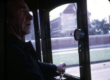  driver driving a tram with the Loreto Convent Sturt St West in the background