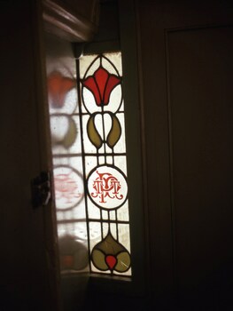 photos of a PMTT stained glass window built in to a door way