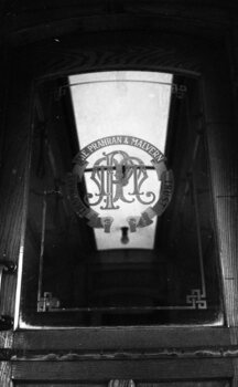 PMTT logo sandblasted onto a saloon door.