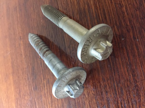 Two Rail Screws (each slightly different) in cardboard box.