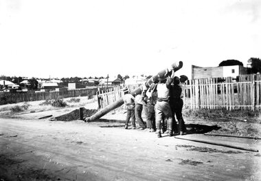 Raising a pole for the overhead electrical wiring for Geelong Tramways. 