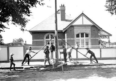 Manually raising a pole for overhead tram lines for Geelong Tramways.