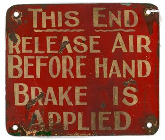 Sign - "THIS END RELEASE AIR BEFORE HAND BRAKE IS APPLIED"