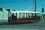 A vintage red and white Bendigo Tramways tram numbered 17, with open-air seating and two people visible in the driver's cabin.