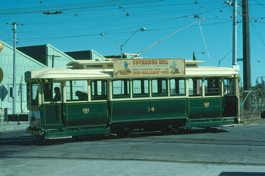 A historic green and cream tram with the number 14 displayed on its side, advertising "Sovereign Hill Goldmining Township".