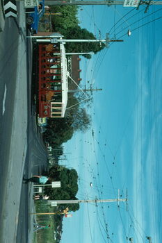 A vintage red and white tram marked "BENDIGO TRAMWAYS" with open-air seating travels along tram tracks.