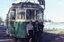 Two BTPS volunteers standind in front of a tram with a Lake in the background.
