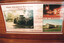 A poster displays three images of trams associated with Victorian Railways. The top left shows a green tram labeled "TRAM No. 41" parked in a grassy, wooded area. The top right image is a nighttime scene of trams at a station. The bottom image shows multiple trams on a railway track in a grassy field. Text reads "FROM VICTORIAN RAILWAYS" and "...TO NEW ST. BRIGHTON..." and "...TO HADDON."