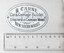 Oval enameled metal plaque with black text on a white background, reading "B. CARNE, Car & Carriage Builder, STRATHFIELD CARRIAGE WORKS, NEW SOUTH WALES."