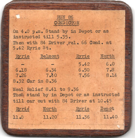 A wooden-framed schedule card titled "RUN 86 CONDUCTOR" with printed text detailing instructions and timetables for a conductor's route.