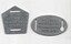 Two metallic tags, one pentagonal and one oval, with the stamped text "IF LOST RETURN TO TRAMWAY OFFICE REWARD".
