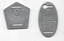 Two metal tags with a stylized "GT" logo; one pentagonal with two horizontal slots, the other oval with a cutout hole at the top and the number "1977" engraved.