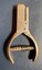 A close-up overhead view of a vintage metal hole or ticket puncher