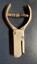 A close-up overhead view of a vintage metal hole or ticket puncher
