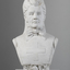 Plaster bust of a woman wearing a stiff, flat garment with medical cross on the chest and a large bow at the neck. Her hair is swept back. She is wearing a nurses cap which has fabric that hangs past her shoulders. A rose is placed under her chest.