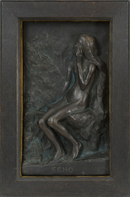 Bronzed relief plaster cast set in deep brown wood frame with mustard or bronze coloured fabric cladding on inside edge of frame. Subject is a naked woman, seated, with long flowing hair. She holds her left hand to her mouth. Rough abstract landscape behind subject.