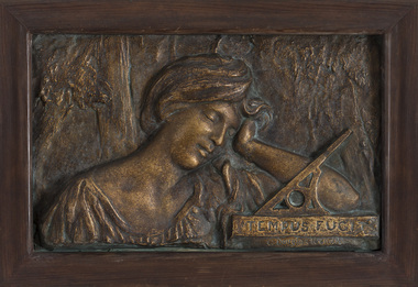 Relief sculpture  of a woman, head and shoulders only. She leans on her left hand, with a sundial in front on her arm labelled 'TEMPUS FUGIT'. The woman wears an open-necked garment, and her hair is loosely pulled away from her face.