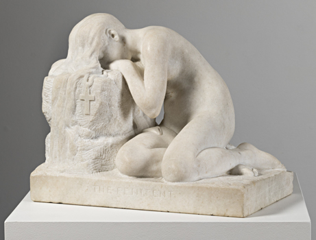 Angled view of marble sculpture of naked female slumped onto her knees, with lowered head. She leans on a shield bearing a cross. She sits on a rectangular base