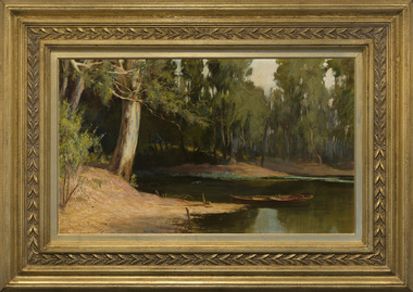 Landscape showing a river with trees on visible left bank. Prominent tree trunk on bank in foreground. Small boat on river. Housed in a decorative gold frame.