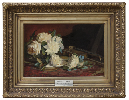 Still life painting of cream or yellow roses on a table partially obscuring a violin or fiddle sit on a red patterned table cloth. Red and brown background.  Housed in a thick decorative gold frame with plaque attached.