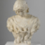 Cream plaster bust of woman. Her hair is parted at the centre, and her head is slightly bowed. She wears a garment with a square neckline. Trumpet lilies cover her bust.