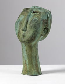 Patinated bronze sculpture with a green finish of a whistling man's head. Eyes are slits and nose is elongated.
