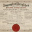 A certificate in mainly black, red and gold ink on cream paper, with decorative floral border. Gives details of the municipality and has a red wax seal at bottom of certificate.