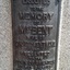 Detail of a bronze plaque which is attached to a granite base.