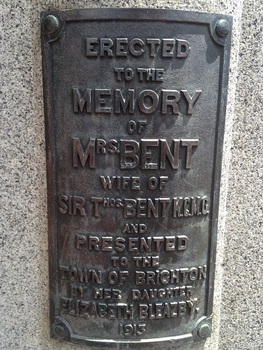 Detail of a bronze plaque which is attached to a granite base.