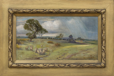 Painting of a landscape with green fields, sheep grazing in foreground to the left. Two large trees to the left, more trees and farm house in background. Cloudy sky and rain coming down on the right. Painting surrounded by thick gilt frame with rectangular flat edges and raised decorative border around work