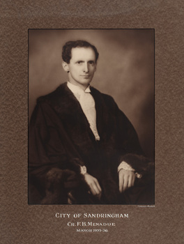 Sepia photograph of a formal portrait of a seated man with dark hair, shown chest up, wearing mayoral robes with fur trims and jabot
