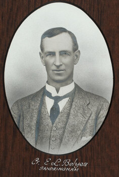 Black and white photograph of an oval portrait of a suited man with dark hair.
