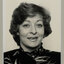 Black and white photographic portrait of a woman with a dark bob