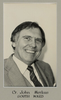 Black and white photographic portrait of a man in a suit and tie