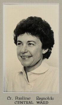 Black and white photographic portrait of a woman with short dark hair and a white shirt.