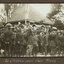 Black and white photograph, soldiers in foreground, stage in background.