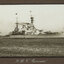 Black and white photograph of a large ship with 2 masts.