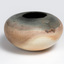 A round earthenware vase in pink and grey tones.