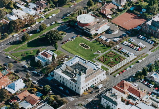 Aerial photograph of Brighton Town Hall, Brighton Library and gardens as well as surrounding streets and houses.