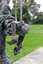 Close up of a metal sculpture of a child holding paper boats in his hands.
