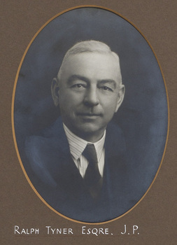 Black and white photograph of a man in a suit with white hair